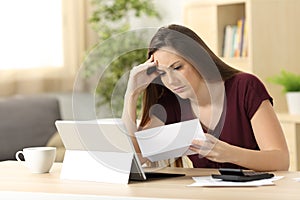 Worried woman calculating accountancy reading a letter photo