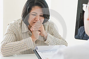 Worried woman crying after receive bad news from diagnosis cancer