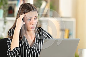 Worried woman discovering error on laptop