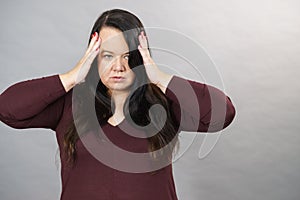 Worried woman having painfull headache