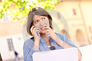 Worried woman with laptop in the park