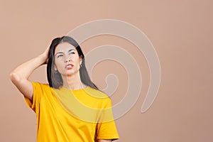 Worried woman looking up with pensive expression