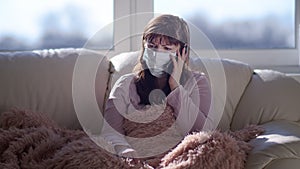 Worried woman in medical mask talking on the phone