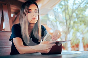 Worried Woman Paying an Expensive Price at the Restaurant