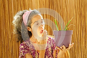 Worried woman about plant in flower pot