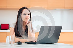 Worried Woman Reading the News at Home in the Kitchen