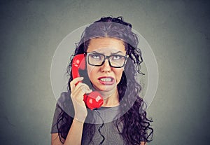 Worried woman receiving bad news on phone