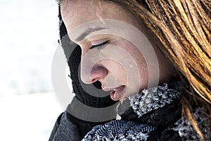 Worried woman in snow covered fields landscape