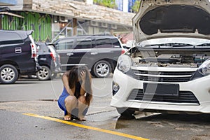 Worried woman in stress stranded on roadside with car engine failure having mechanic problem needing repair service and assistance