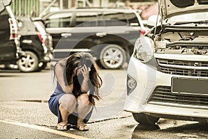 Worried woman in stress stranded on roadside with car engine failure having mechanic problem needing repair service and assistance