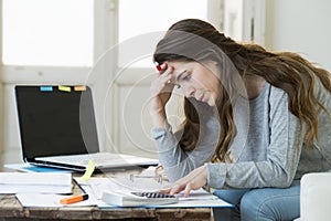 Worried woman suffering stress doing domestic accounting paperwork bills and invoices