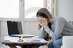 Worried woman suffering stress doing domestic accounting paperwork bills and invoices