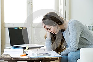 Worried woman suffering stress doing domestic accounting paperwork bills and invoices