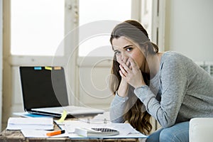 Worried woman suffering stress doing domestic accounting paperwork bills and invoices