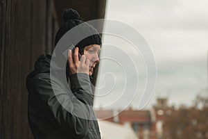 Worried woman talking on mobile phone on street