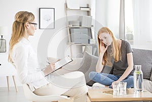 Worried woman talking with therapist