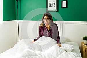 Worried woman waking up from a nightmare