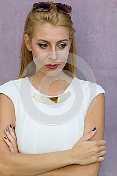 Worried woman in white dress