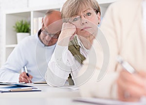 Worried woman writing difficult exam