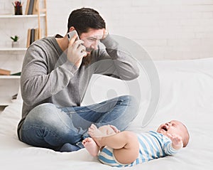 Worried young father with his crying baby