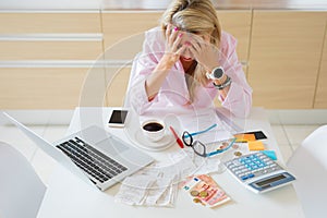 Worried housewife having money problems and bills to pay photo