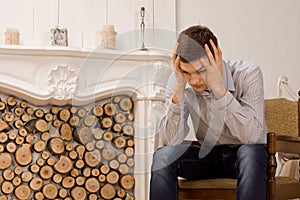 Worried young man with his head in his hands