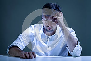 Worried young man sitiing at the table