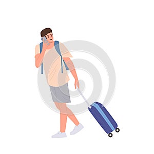Worried young man traveler carrying luggage bag talking by mobile phone isolated on white background