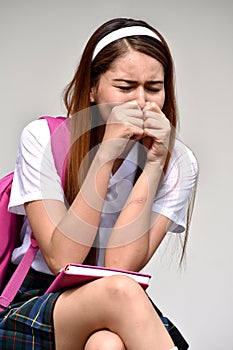 Worrisome Female Student Wearing Uniform With Books