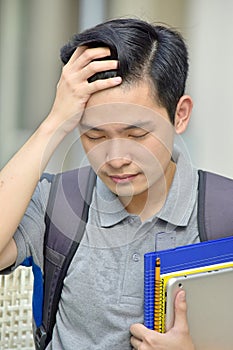 Worrisome Male Student With Notebooks