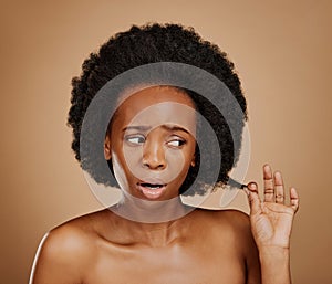 Worry, black woman and hair problem for afro in studio isolated on a brown background. Damage, hairstyle and sad African