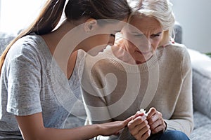 Worrying millennial lady sitting next to upset frustrated mommy.