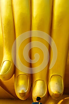 Worship The Big Hand Buddha at Wat Muang Temple, Angthong, Thailand.Wat Muang with golden giant big Buddha statue in Thailand