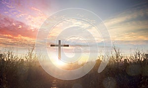 worship concept, Silhouette cross Jesus Christ on grass autumn sunrise background