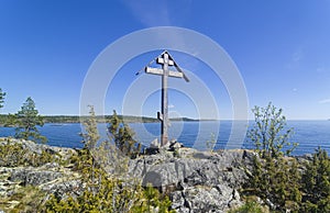 Worship cross on a rock on the shore of the Ladoga Lake