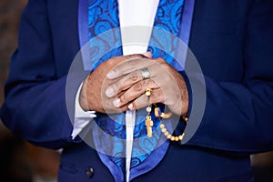 Worship, praying or hands of man with rosary for God, faith or belief for support or hope in Christian religion. Closeup