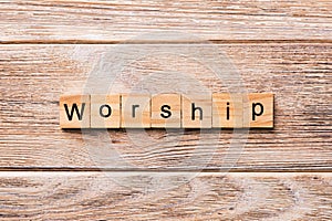 Worship word written on wood block. Worship text on wooden table for your desing, concept