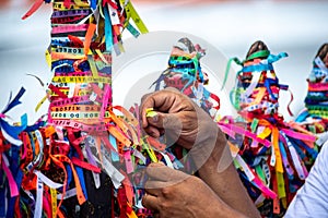 Worshipers are tying colored ribbons to the railing of the Senhor do Bonfim church on the first Friday of 2023