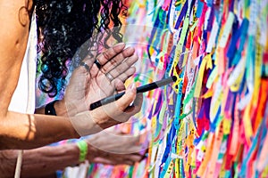 Worshipers are tying colored ribbons to the railing of the Senhor do Bonfim church on the first Friday of 2023