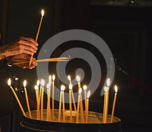 A worshipper lights candles at the Church of the Holy Sepulchre, Jerusalem photo