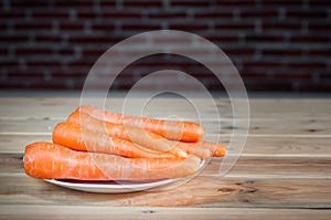 Wortel or fresh carrots on a white plate photo