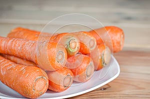 Wortel or fresh carrots on a white plate photo