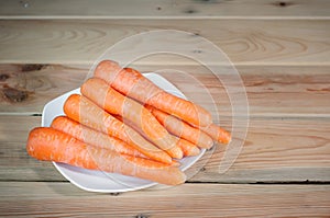 Wortel or fresh carrots on a white plate photo