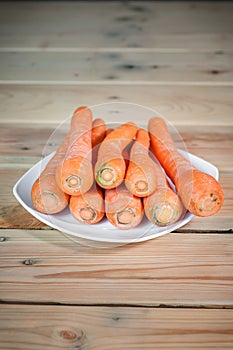 Wortel or fresh carrots on a white plate photo