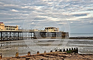 Worthing pier and groynes on the beach photo