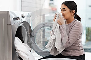 Would you get a nose full of this. a beautiful young woman doing the laundry at home.