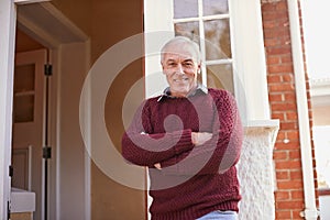 Would you like to come in. Portrait of a happy senior man standing near the doorway to his home.