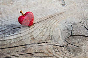 Wounded red heart shape pierced by rusty nail