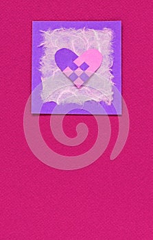 Woven heart on a pink background