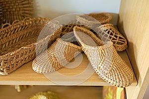 Woven straw slippers. Background with selective focus and copy space